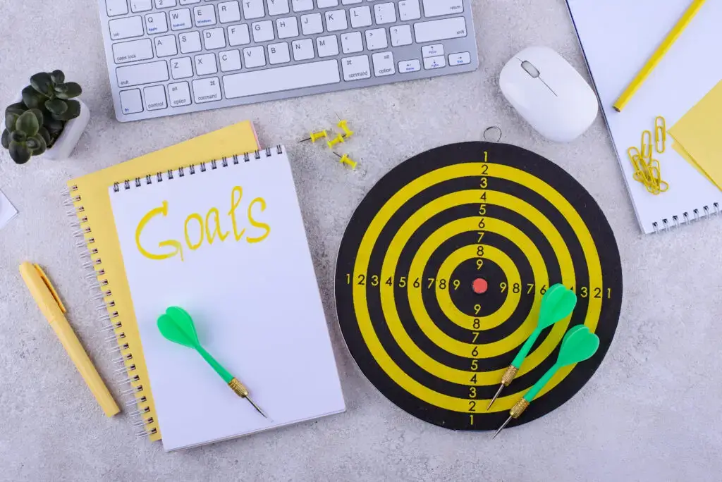Target and goal concept with darts, arrows, and office accessories